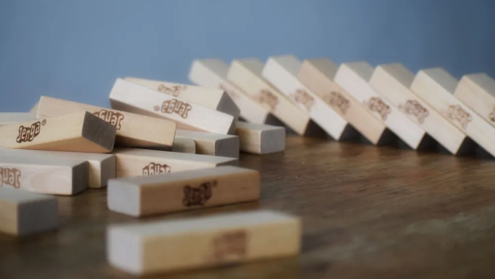 Bloques de madera derrumbados sobre una mesa después de caerse una torre