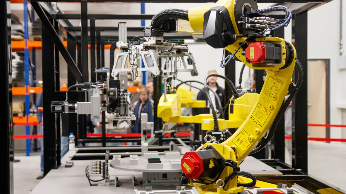 Brazo robótico industrial amarillo en una planta de fabricación moderna